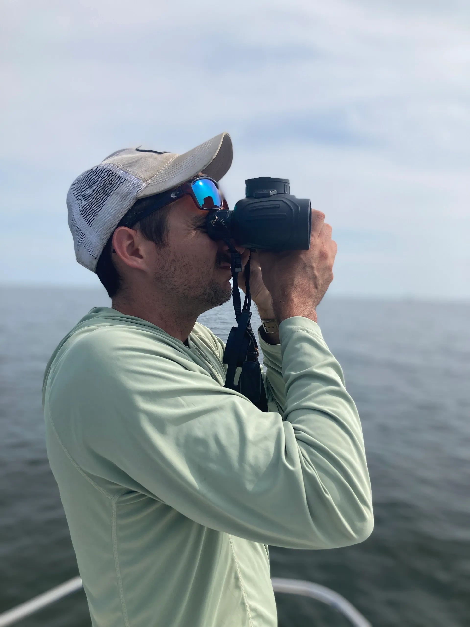 Captain Jonathan Bland holding a fish on his boat