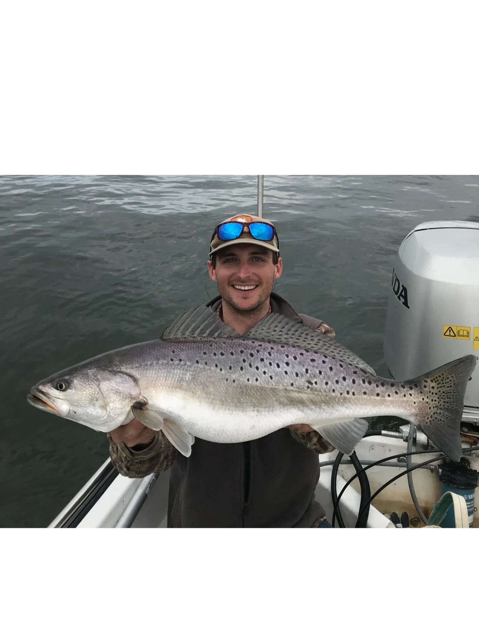 Captain holding fish on boat