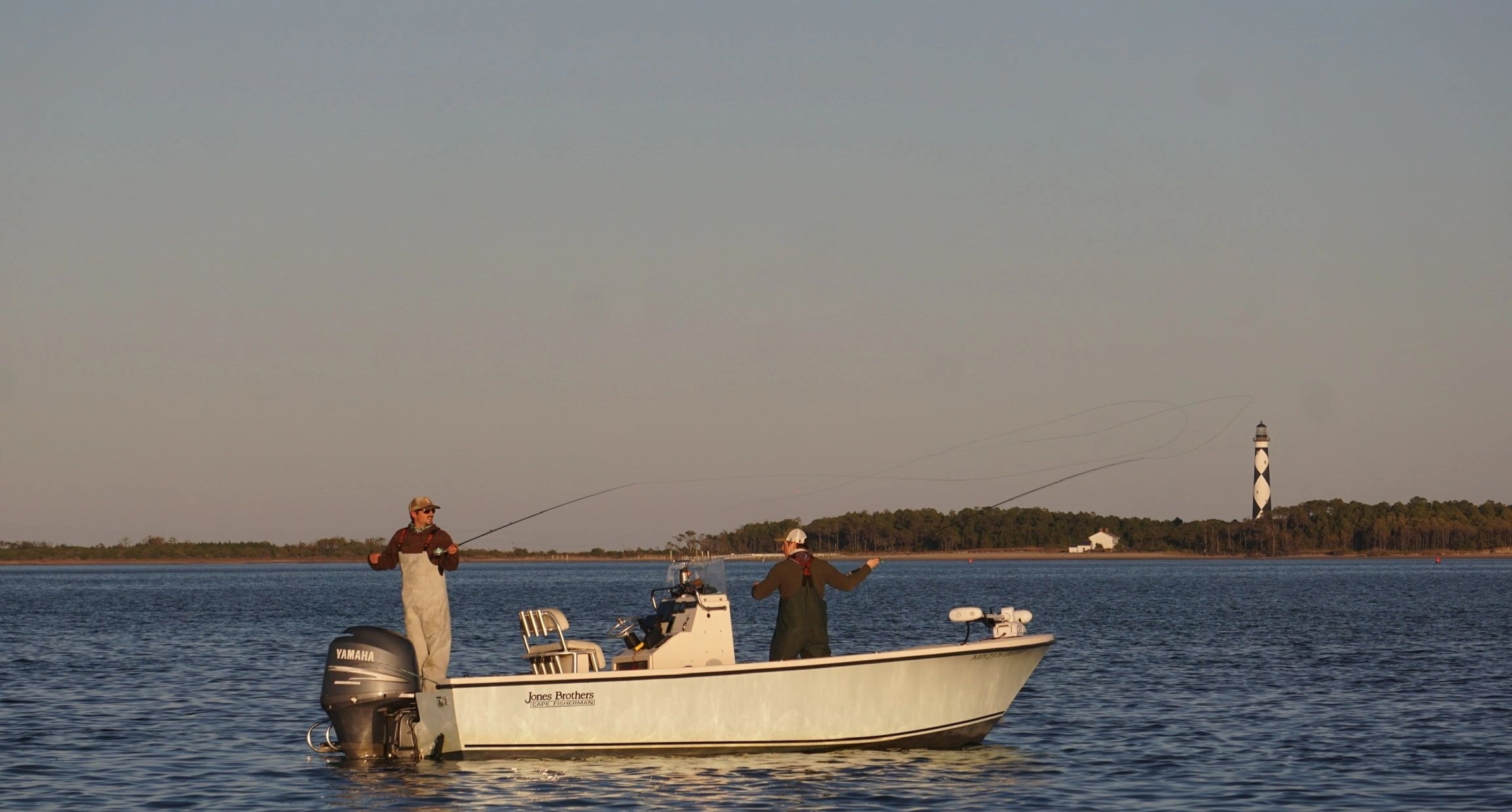 Two fishermen with striped bass
